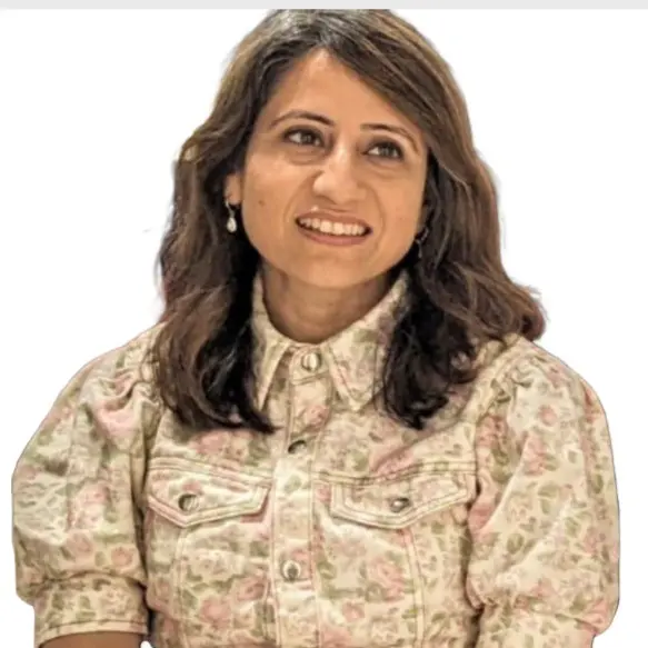 Shubhra-Photo Woman in floral shirt smiling.